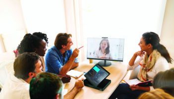 People talking on video conference in office